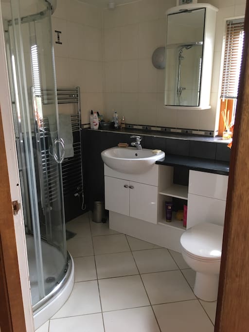 Private ensuite bathroom with shower and bath
