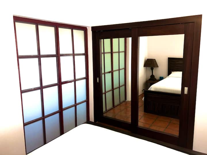 Second bedroom with one queen and one single bed and large closet with mirrored doors.