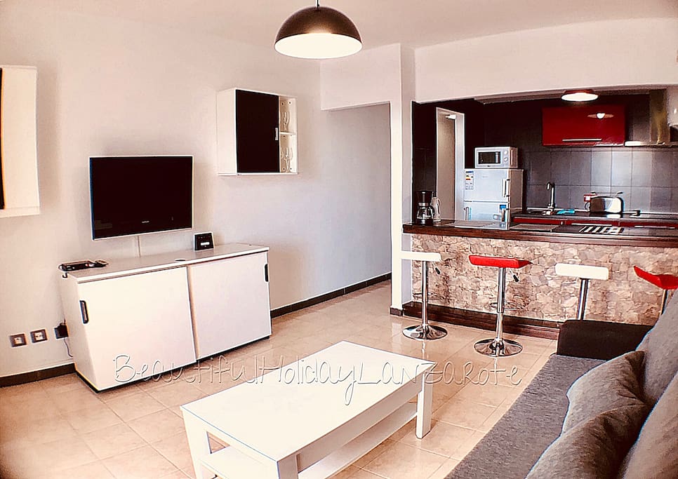 living room with satellite tv, wifi and kitchen area