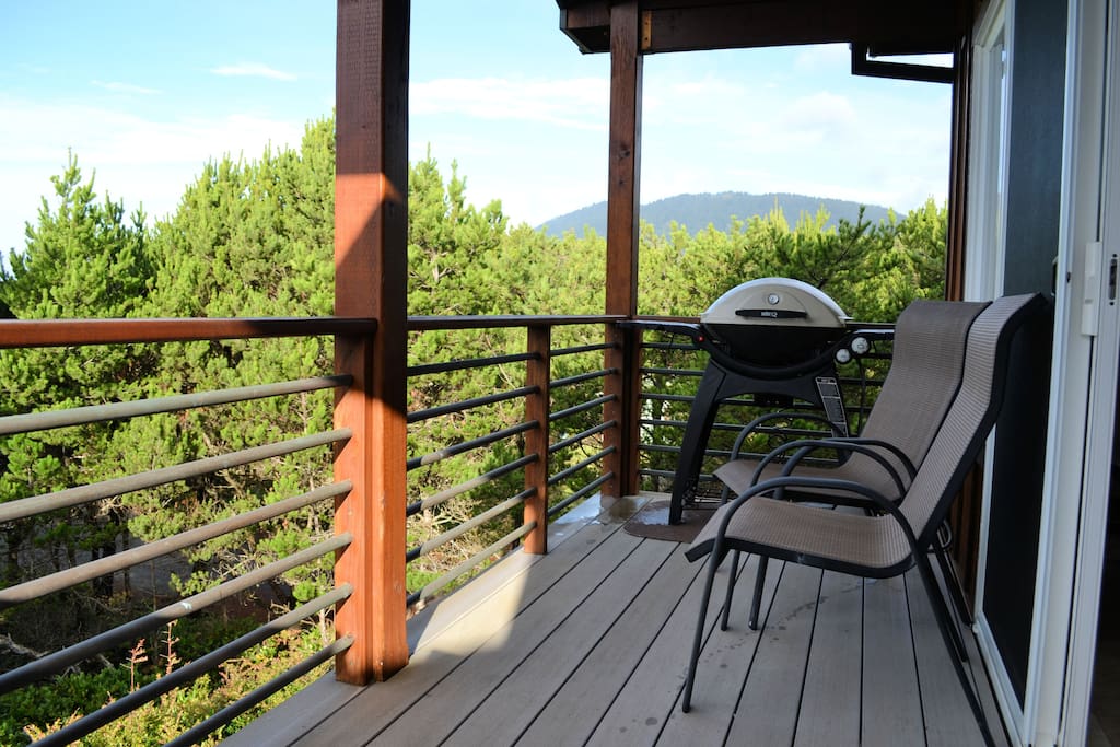 Upper deck with 4 chairs and propane BBQ and views of Neah-kah-nie mountain and peak-a-boo views of the ocean