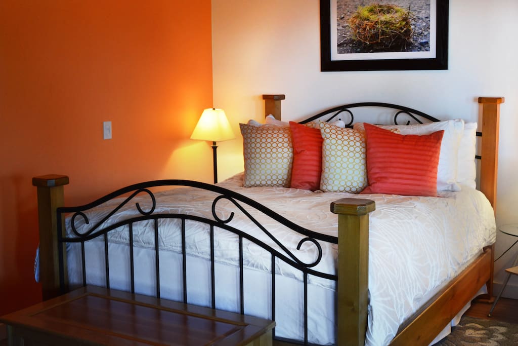 The second bed is in a bright open bedroom with a comfortable feather mattress and pillows, looking out over the island view.