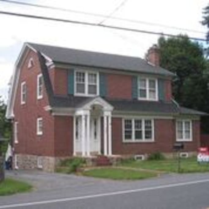 House as viewed from the road. Parking is off street, in drive-way, as well as in front of house.