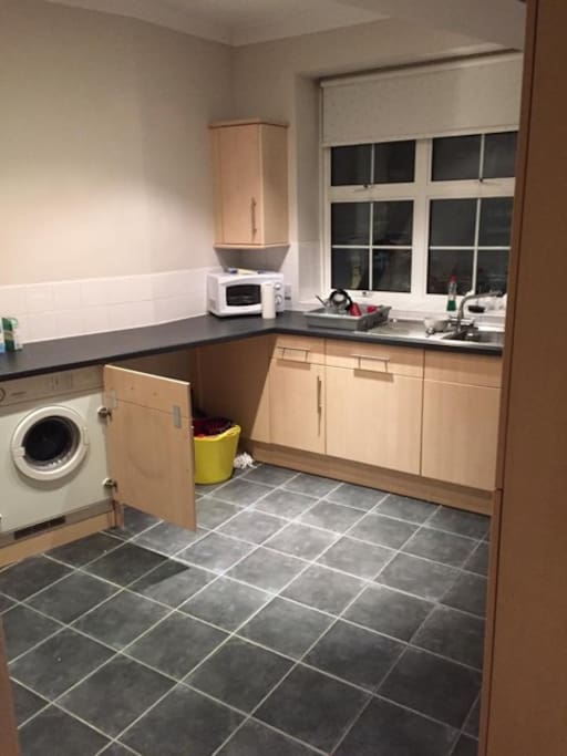 Modern kitchen with washer and dryer