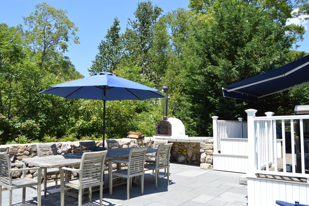 Gracious, private patio, large table for outdoor dining and a wood fired pizza oven!
