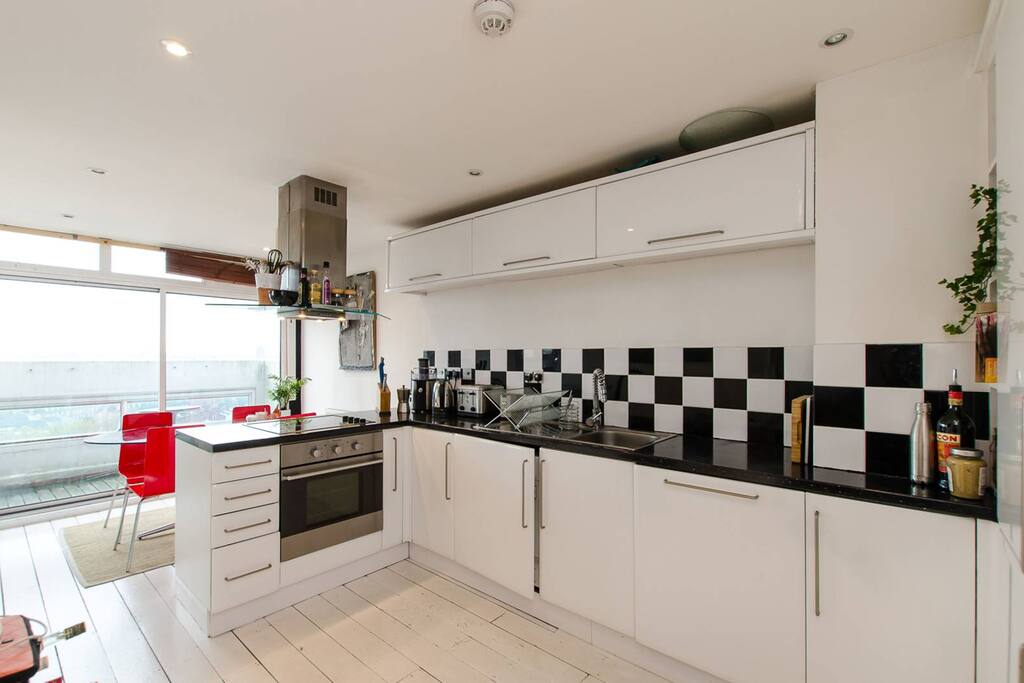 Kitchen and open plan dining area, plus door onto balcony