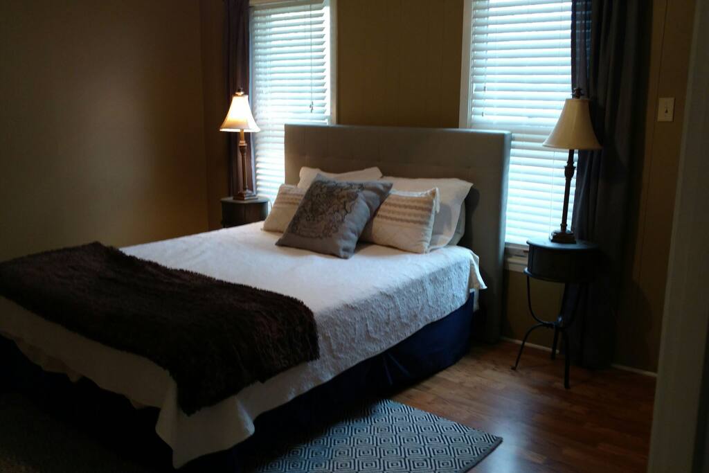 Queen size bed with dresser and TV