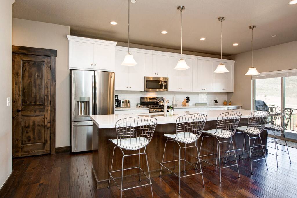 Sliding glass doors lead to the mountain-view patio and gas BBQ grill.