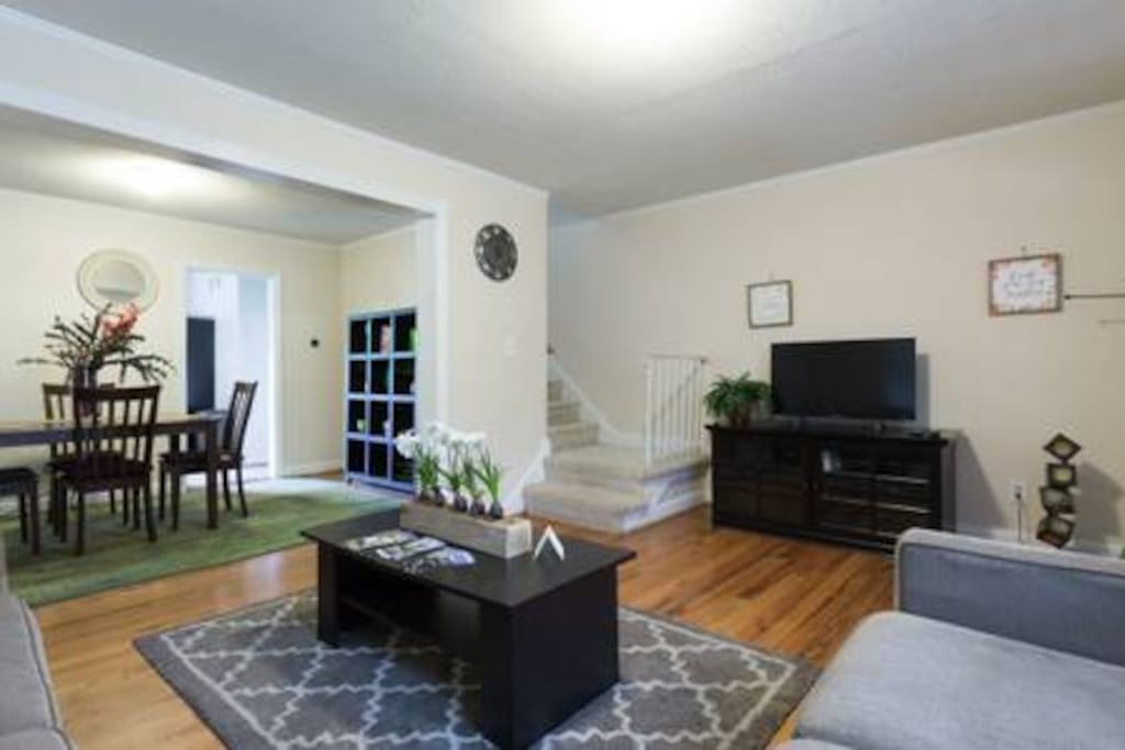 View of dining room, living room, and stairs to the second floor