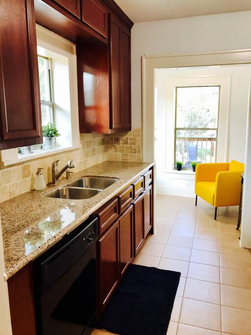 A full kitchen with all of the equipment and a cozy coffee bar.