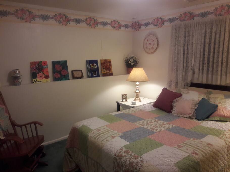 Bedroom 1--The Flower Room with queen bed, glider rocker, closet