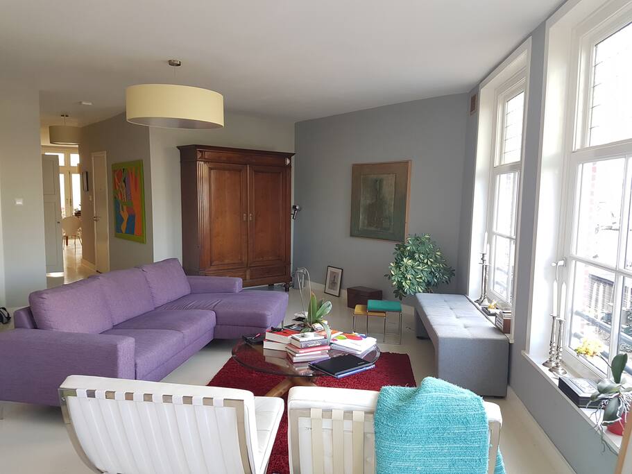 Living room (the cushions at the back of the couch come off, making a very comfortable single bed). I often sleep here instead of in the bedroom because the shadow play on the walls and ceilings at night and the sunrise in the morning over the canal are amazing!