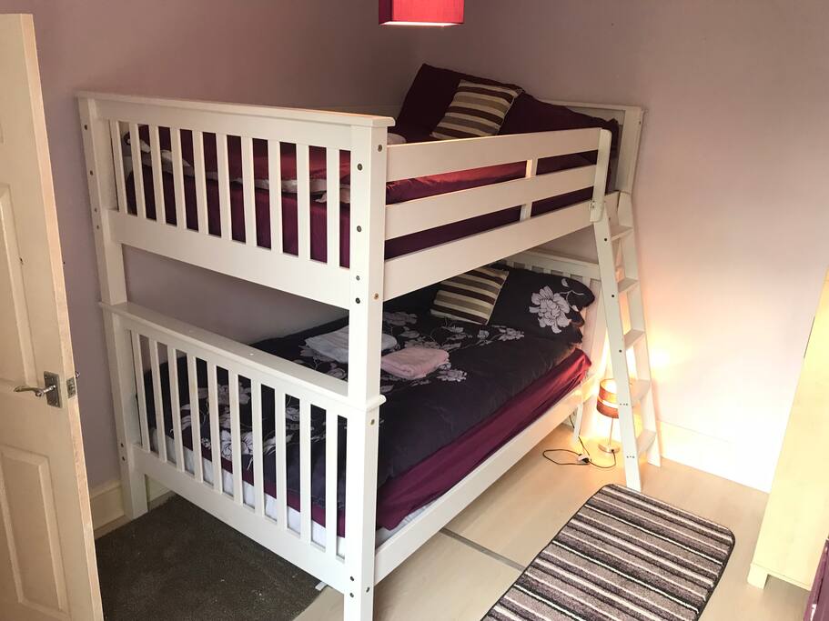 Bunk double bed and wardrobe on the right of the photo