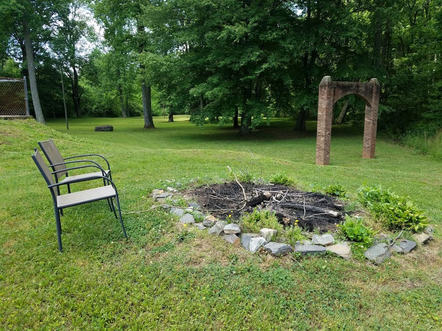 Bonfire circle with view of side yard beyond