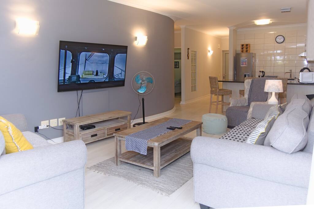 The open plan lounge is a great size for friends and family. Enjoy DSTV on our large flat screen TV.