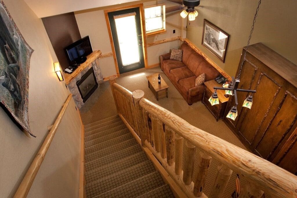 Walk down to staircase into the open-concept living area and relax in the common areas of the suite with your group