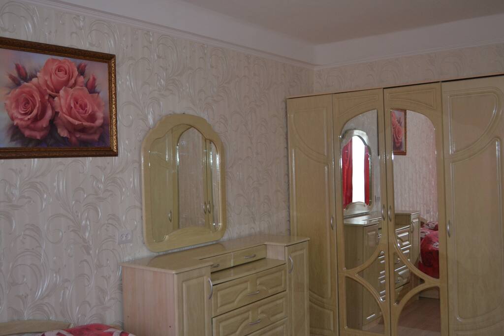 This is a bedroom. A bed with an orthopedic mattress and a TV. There is a balcony where you can go out to breathe air or smoke