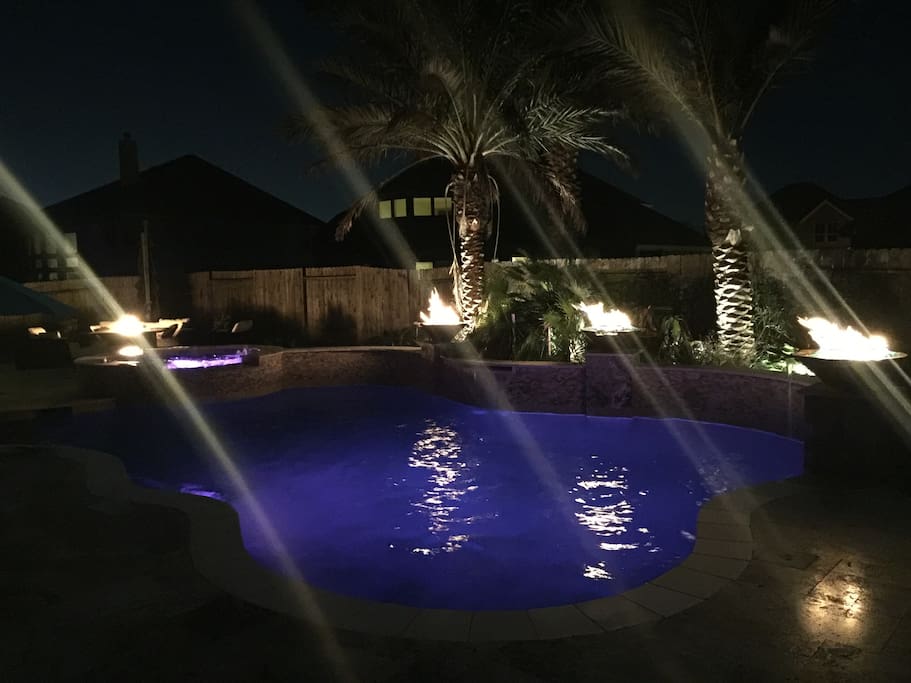 Heated pool! Fire bowls also have a waterfall flowing from them into the pool. Also has built in surround sound around pool