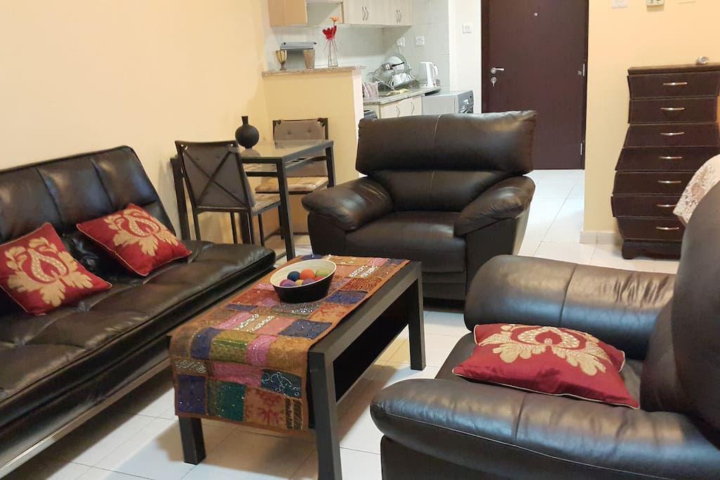 Living room with comfortable leather chairs. The Sofa open as Sofabed, or recliner similar to beach chair for two