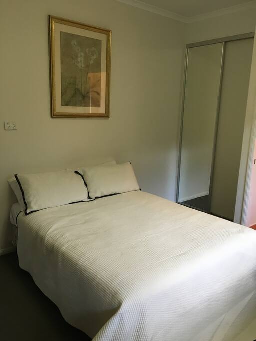 Room has cupboard with mirror.
