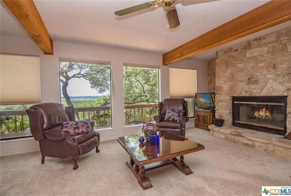 warm living room with FP and views