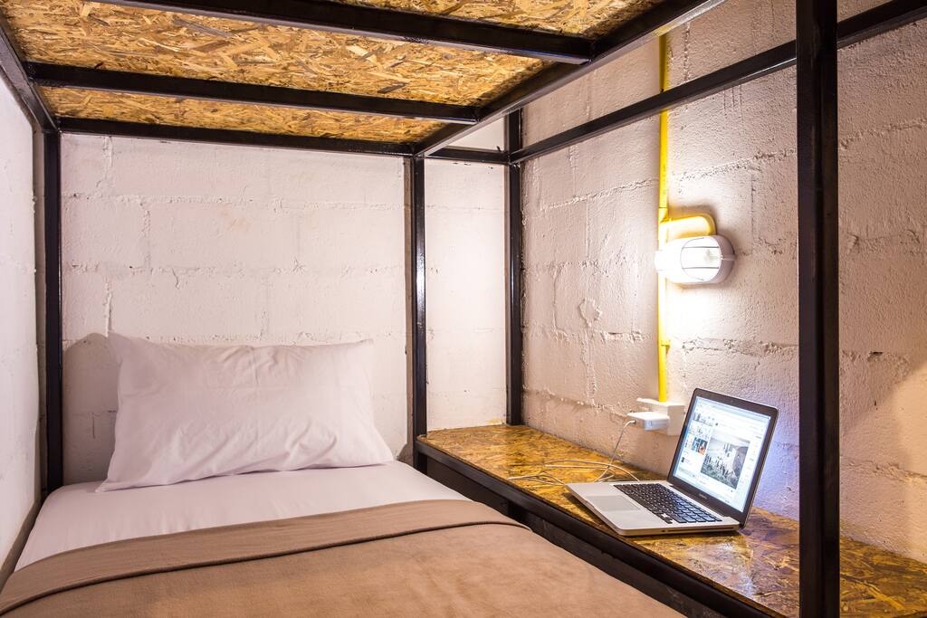 Capsule Beds
Capsule beds within the rooms provide individual guests their own private/enclosed space with dividing walls and an easy-slide privacy curtain. Each of the capsule beds has its own large reading light & power outlet, a hanging clothes rack, writing desk/shelf space and an extra large twin bed with additional mattress pad for comfort.