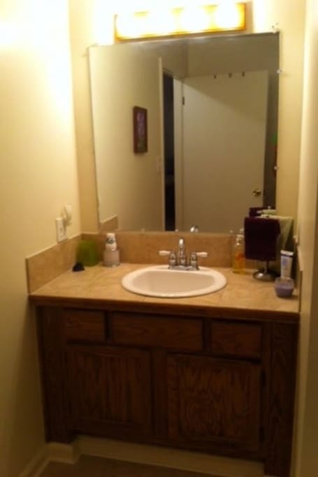 Vanity and sink in spacious bathroom