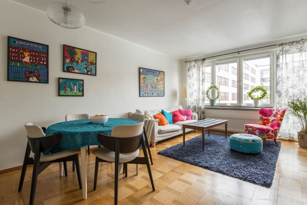 Living room with sofa, dining table and TV.