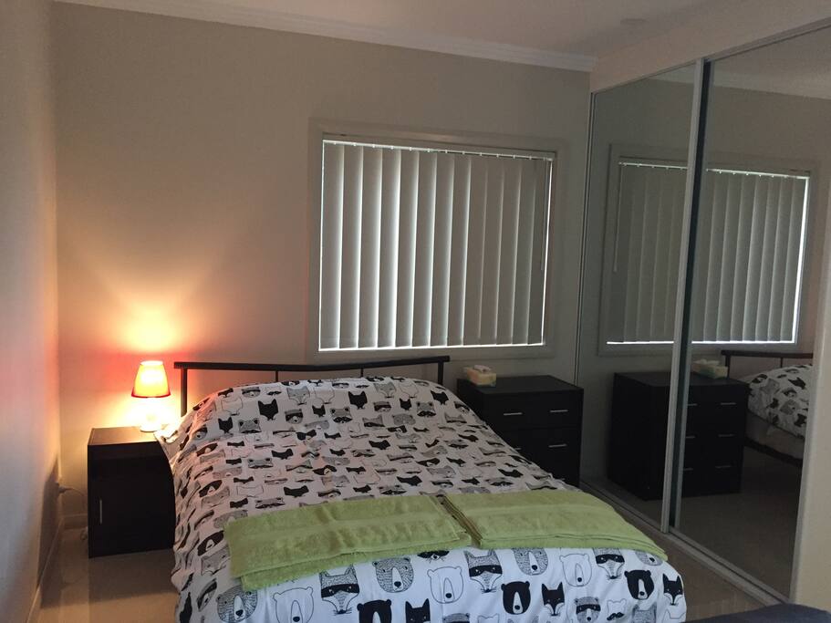 Bedroom with double bed size mattress , 2 pillows and 1 quilt