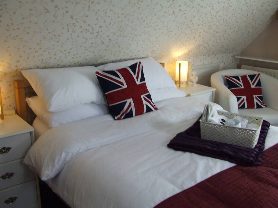 Double bed with mattress topper and Crisp White Linen.