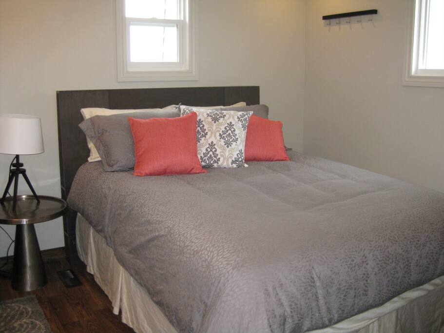 Cozy queen size bed with luxury bedding for a great sleep.