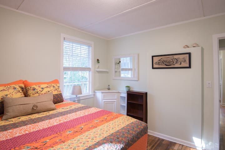Bedroom One with new queen mattress, artisan quilt, and original art work from David Hale of Athens, GA