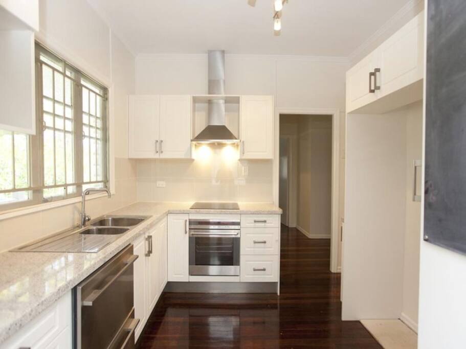 Clean modern kitchen with induction cooktop.