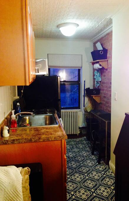 Breakfast bar against charming exposed brick wall. A/C unit is located in the window in summer.