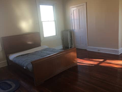 Large, bright room, has wood floors