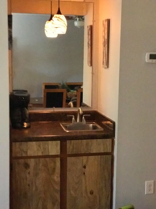 Wet bar with coffee maker.