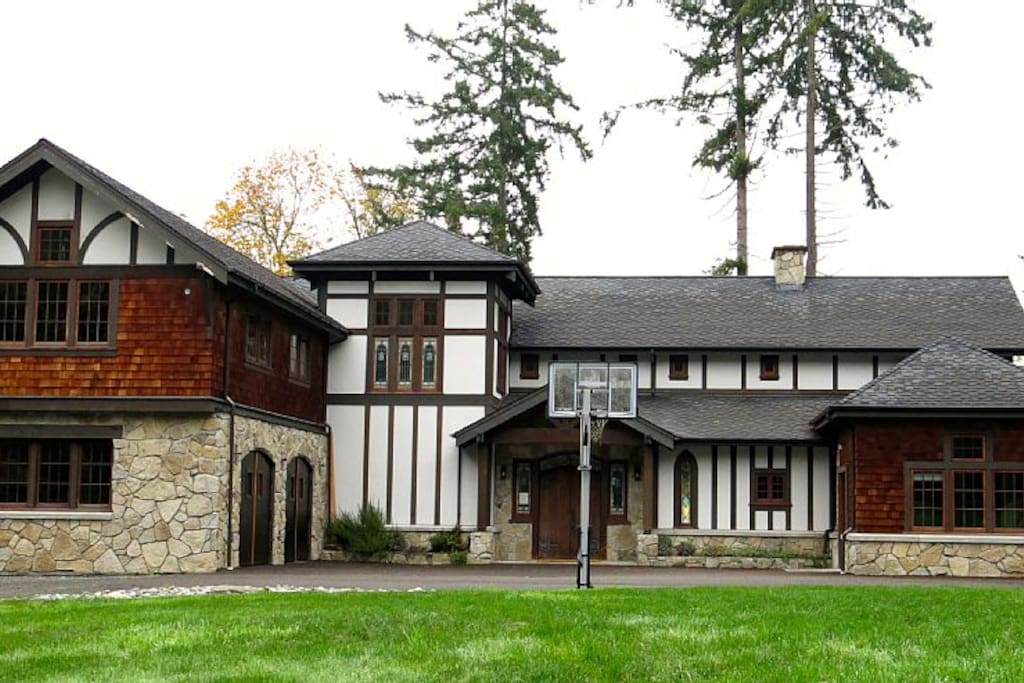 View of house from driveway with basketball hoop out front.