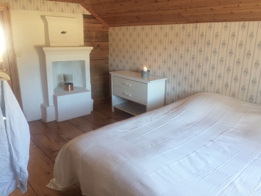 A little fireplace in the upper bedroom is cosy.