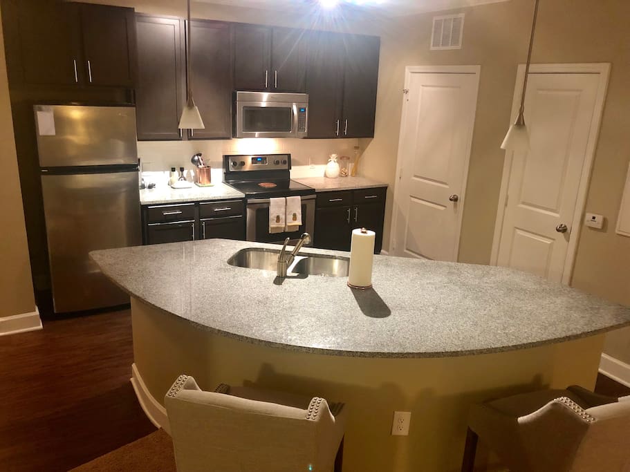 Updated kitchen with granite countertops and island seating