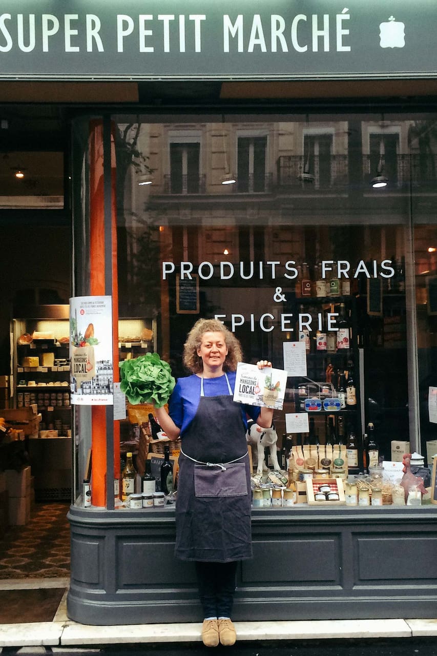 woman standing in front of a french deli