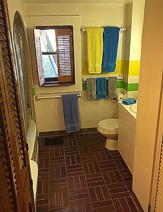 Shared bathroom equipped with full tub & shower.