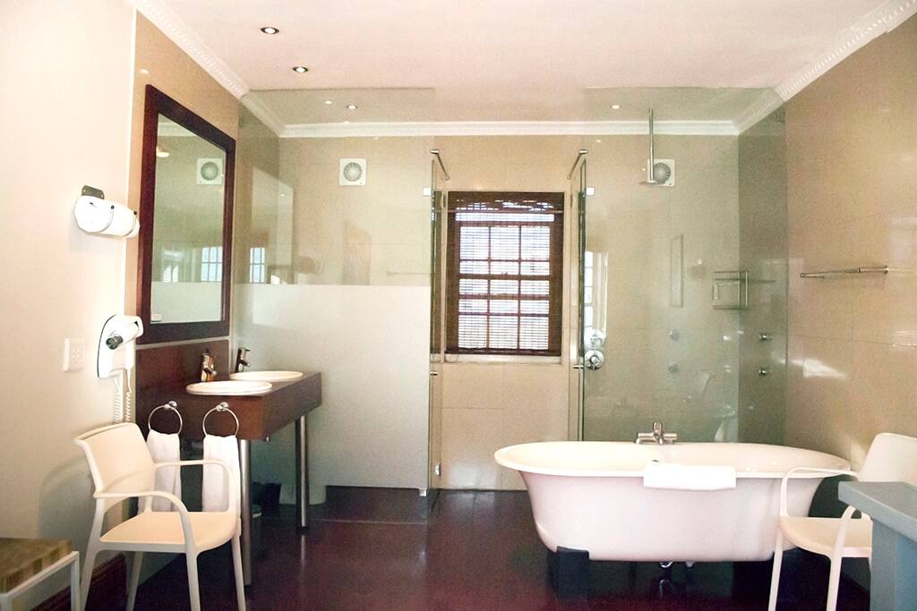 Open plan bathroom with shower and bath