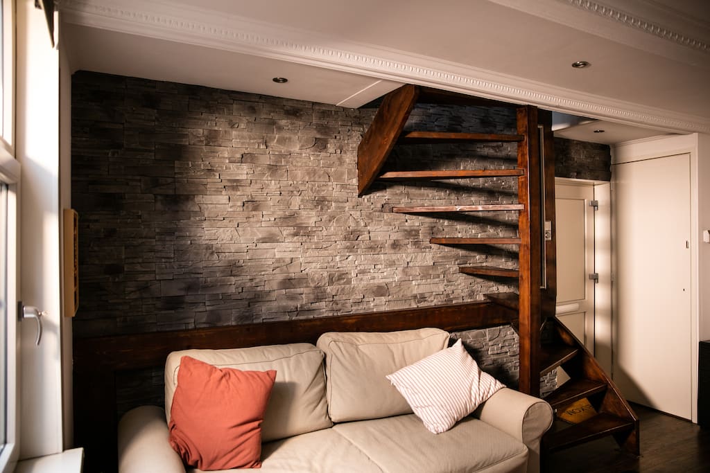 Sofabed as sofa, stairs to kitchen