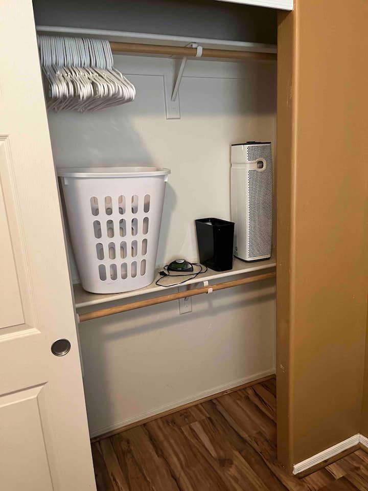 bedroom 3 laundry, trash, alarm clock, hangers, air filter/white noise fan, luggage rack