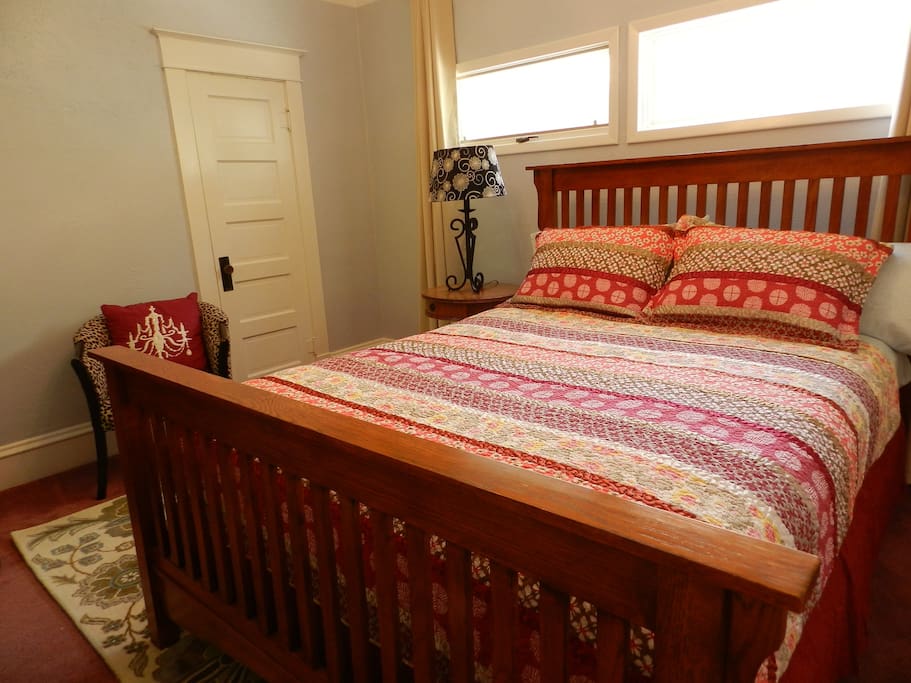 Bedroom with queen size bed, door is to private bathroom