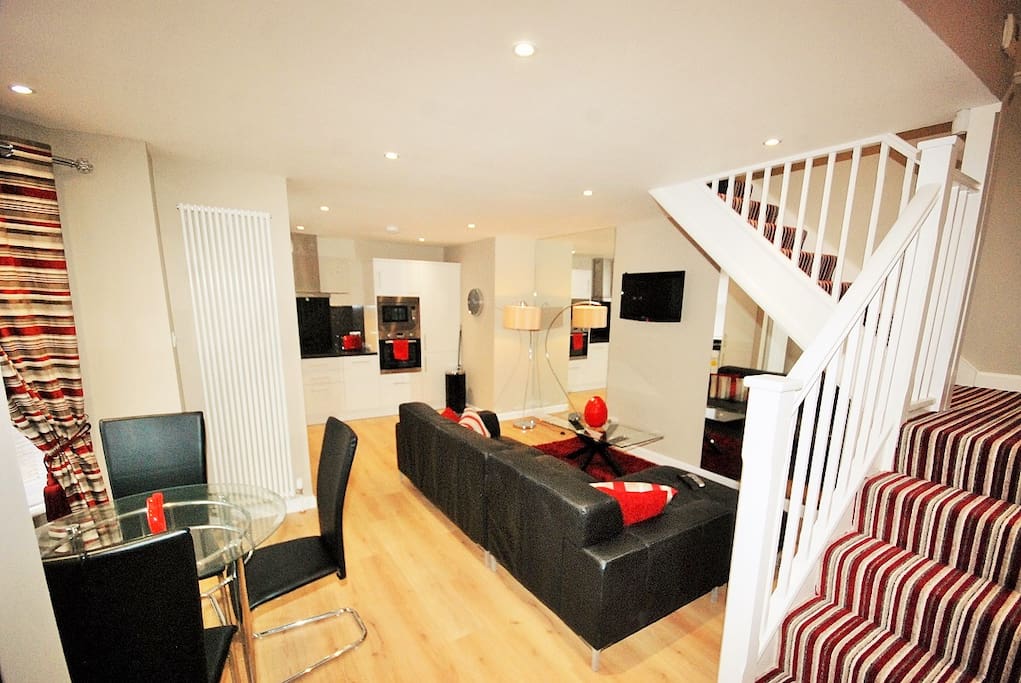 Open plan living... tv connected to dvd and freesat/freeview box which are stored under stairs. Wifi available throughout the apartment.