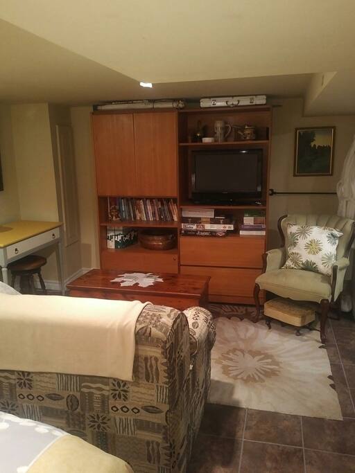 sitting area with TV, small writing/computer desk, sofa bed Couch pulls out to double bed.