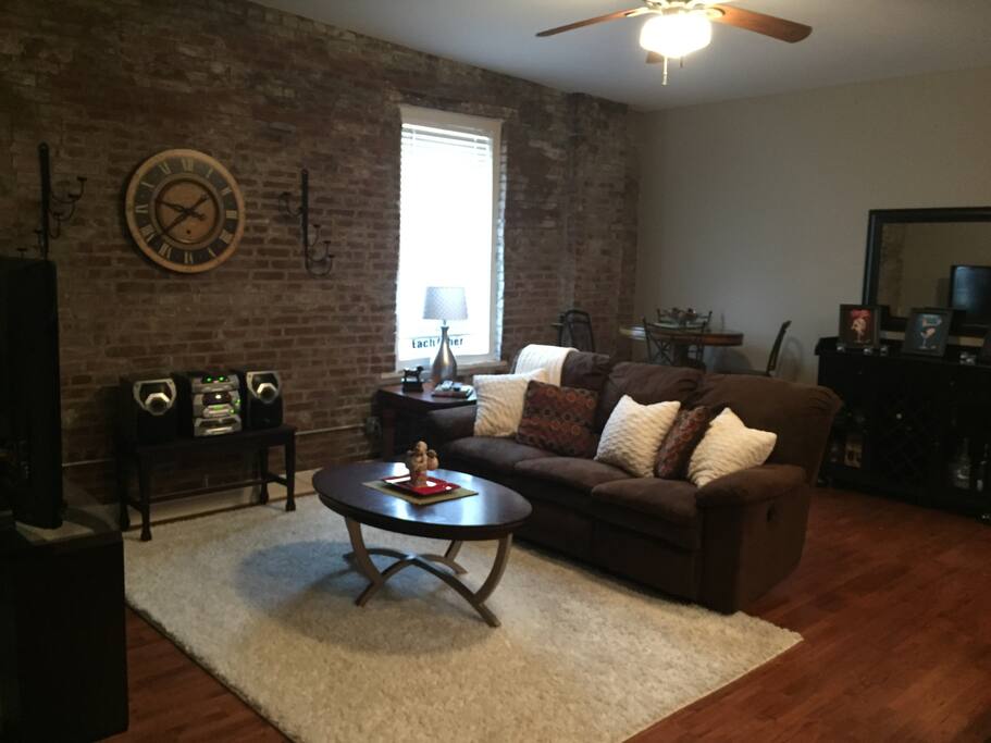 Family room features plush sofa, cocktail table and chairs.
