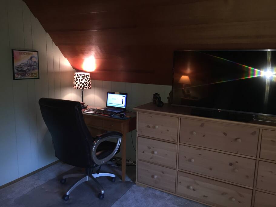 Desk in the master bedroom along with a large flat screen Smart TV with Netflix.