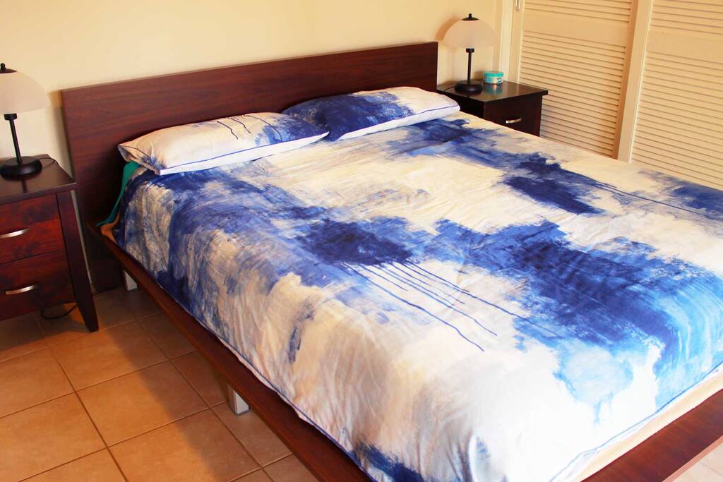 Downstairs queen size bed. Bedroom has ceiling fan and air conditioner.