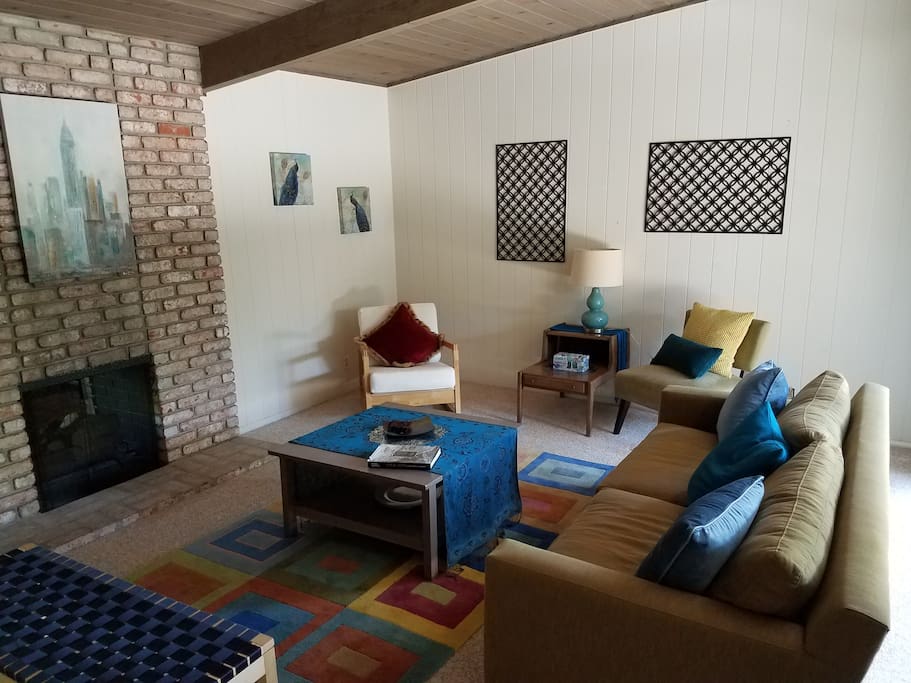 Large woodburning fireplace that is open from both the living room and the family room
